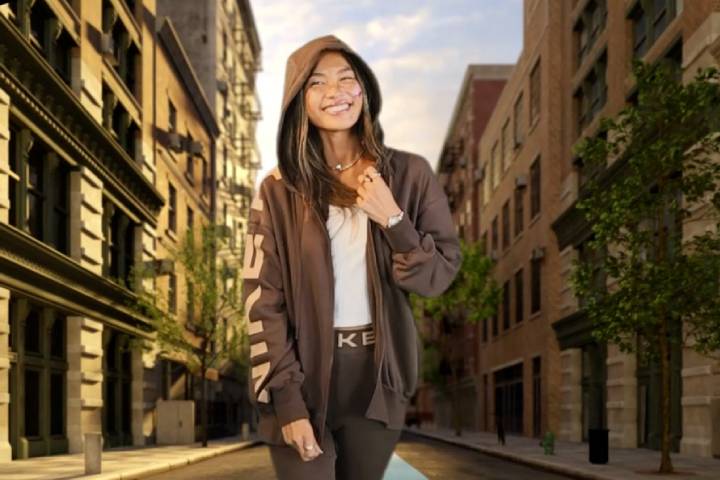 Women in green hoodie is superimposed onto a virtual background depicting a city street